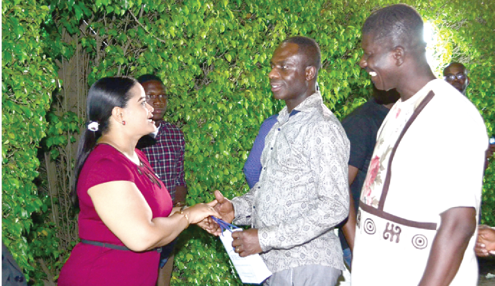 Mrs Yvonne Eyeson (left) engages some of the clients present